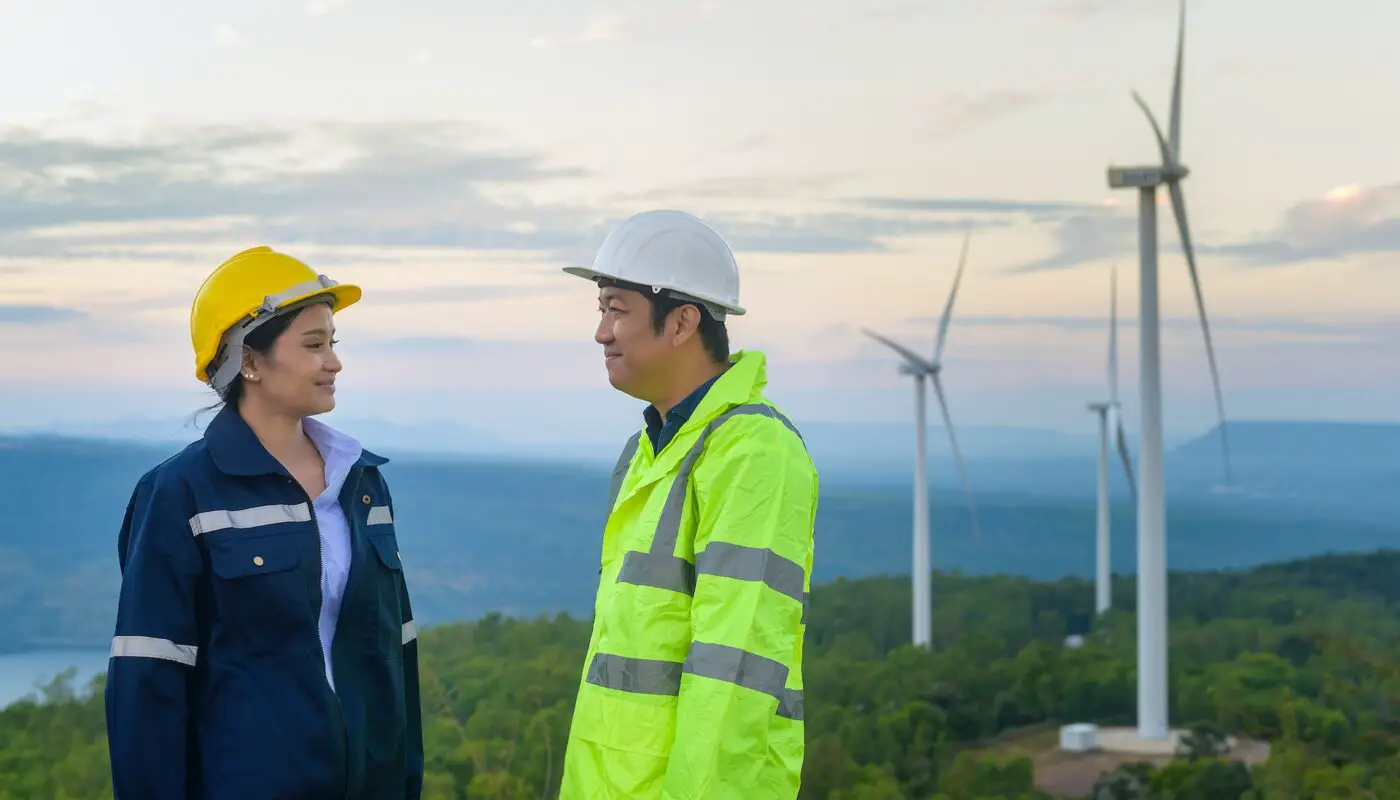 Workers at wind farm - invest in wind energy
