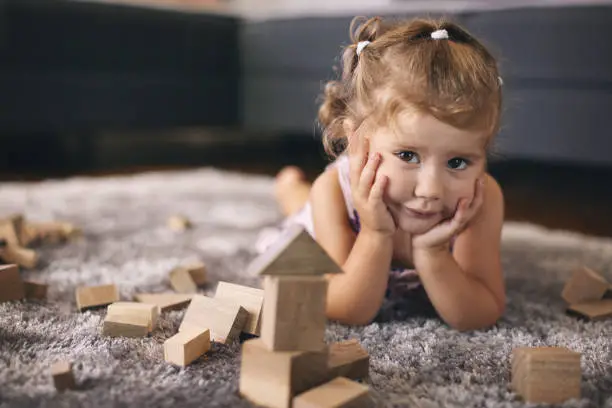 child with wooden toys