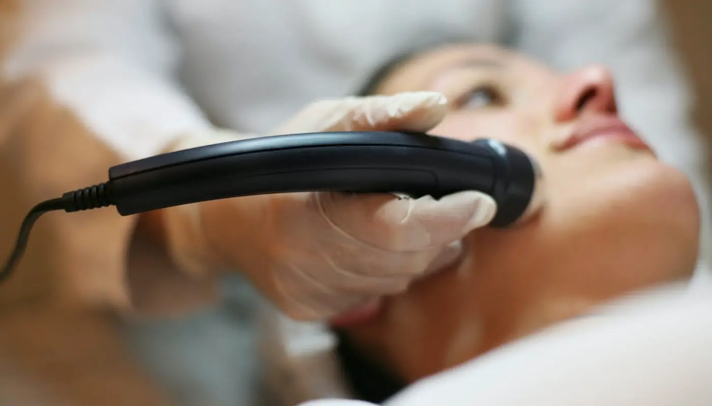 A professional administering Laser Treatment in Sydney for skin rejuvenation