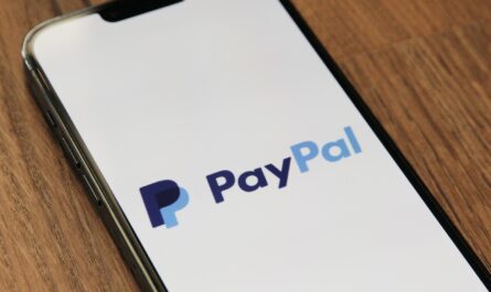 A person transferring money to PayPal from their credit card on a smartphone.
