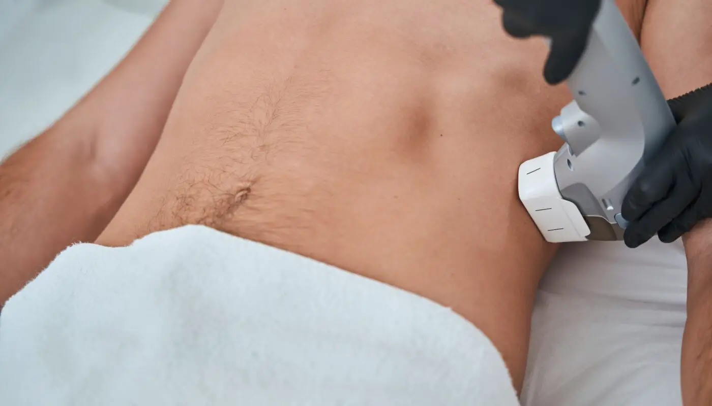 A CoolSculpting technician in Denver applying the specialized applicator to a patient's target area