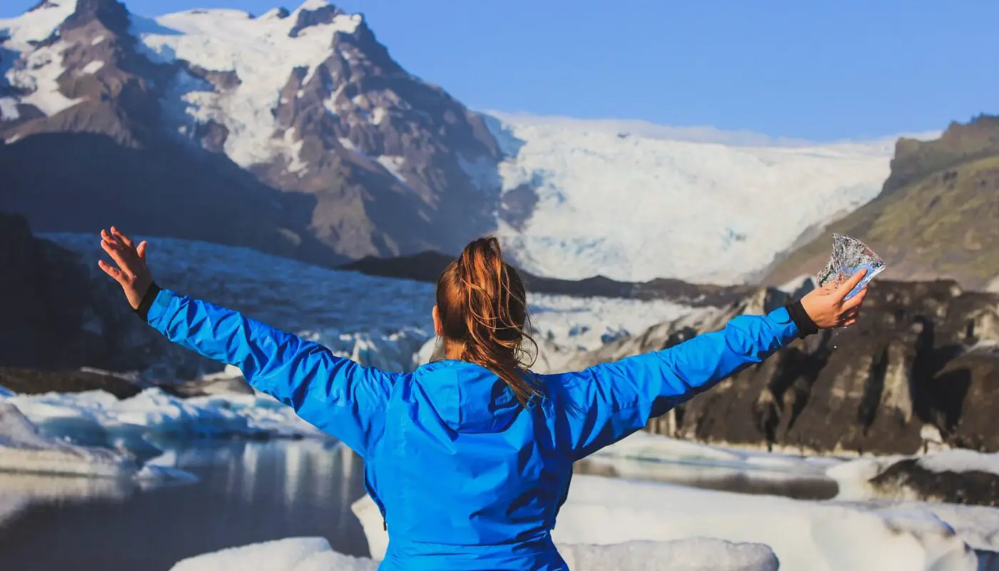 Woman wearing Outdoor Baselayers while hiking near a glacier.