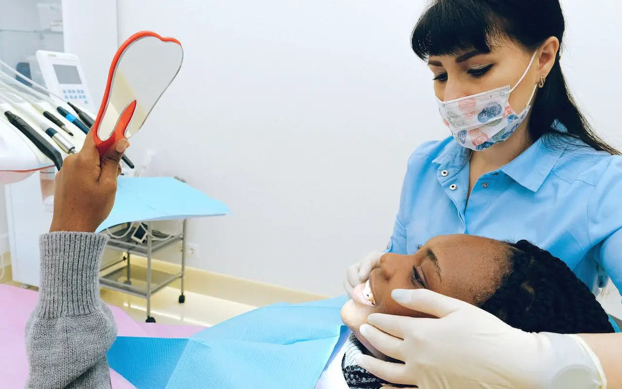 A person practicing Porcelain Veneers Care with proper dental hygiene tools.