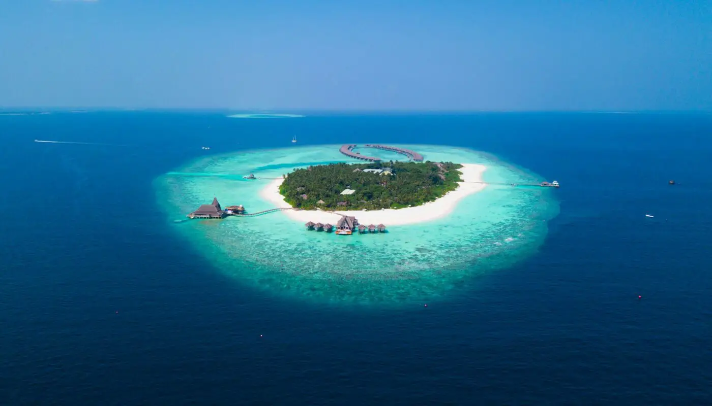 Anantara Kihavah Maldives Villas, Maldives - Breathtaking view of a tropical island resort, embodying paradise with crystal-clear waters and lush landscapes.