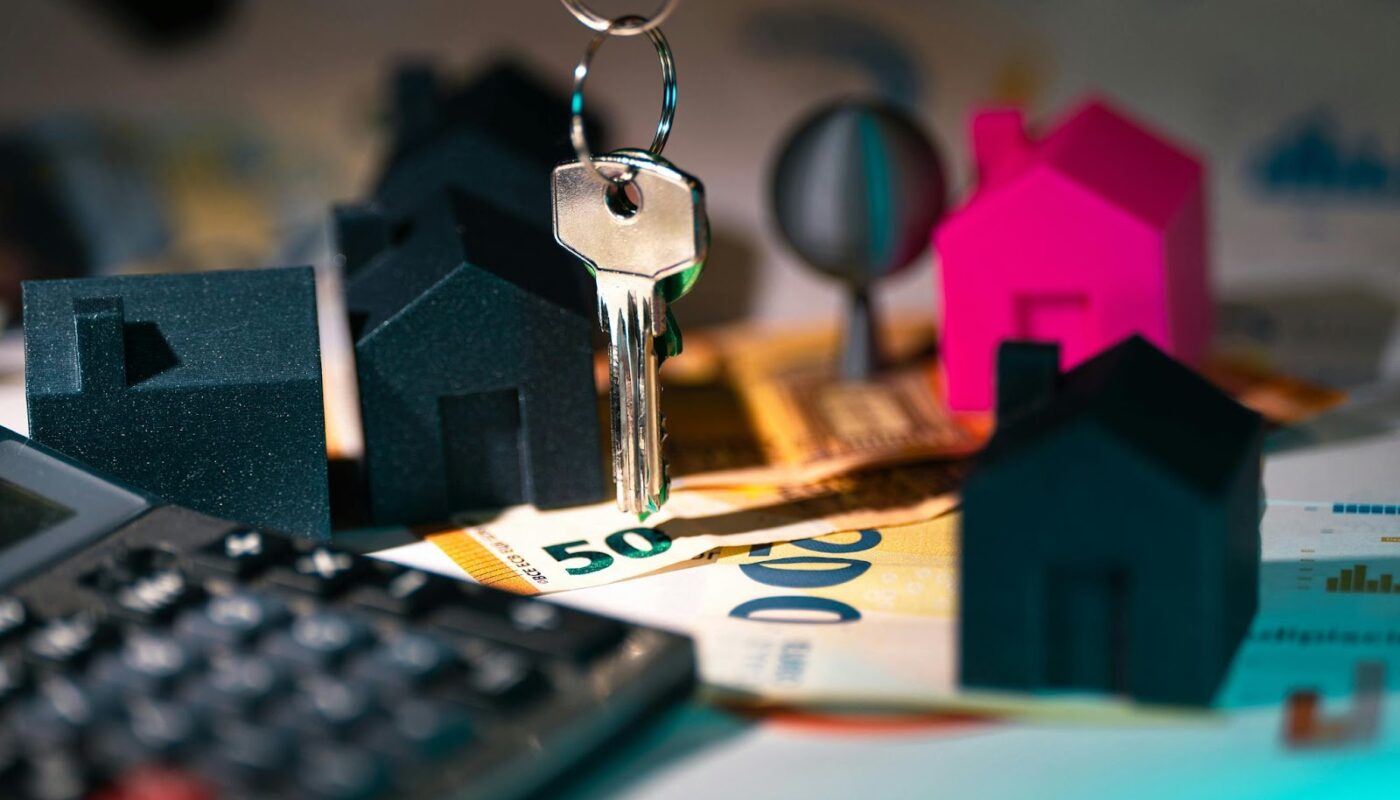 a keychain on a key chain with small houses and calculator