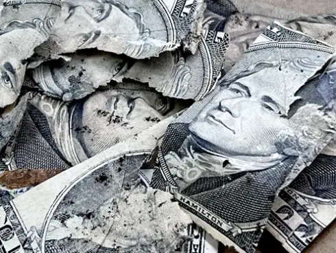 a close up of a crumpled dollar bill