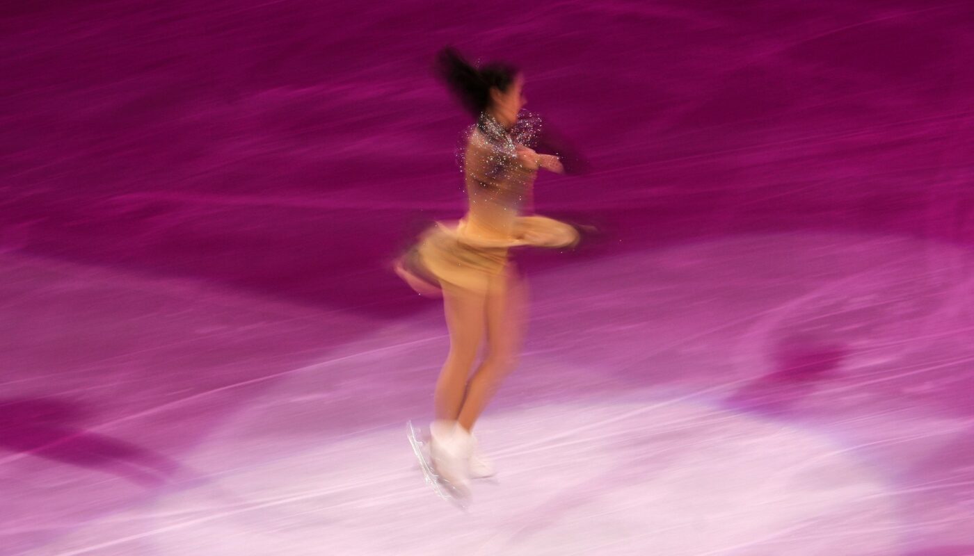 Blurred figure skating performance on ice